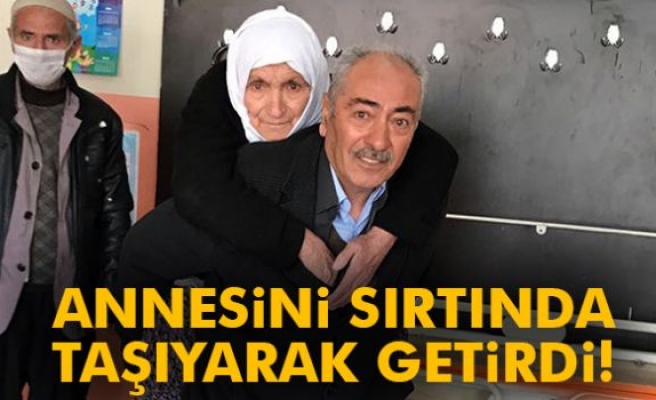 Annesini sırtında taşıyarak oy kullanmaya getirdi