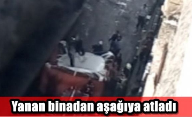 Yanan binadan aşağıya atladı